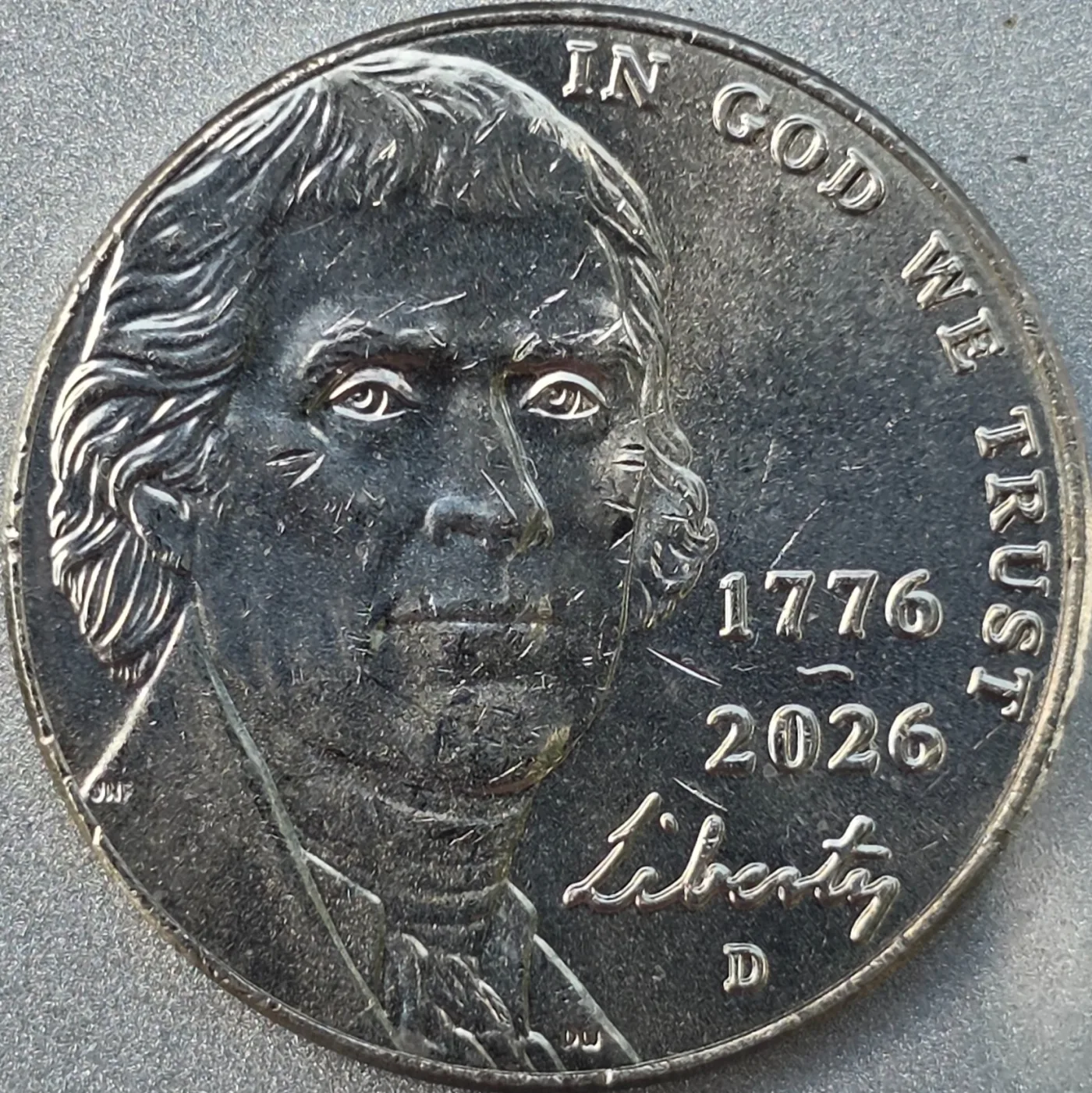 Obverse of a 2026 Jefferson nickel with the stacked dual date 1776 over 2026 beside Jefferson's portrait, the word Liberty in script, and a D mint mark