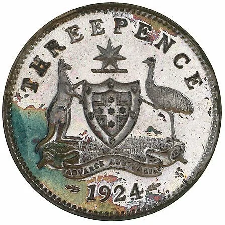 Reverse of a small silver Australian threepence dated 1924, a shield divided by a plain cross bearing stars, supported by a kangaroo and an emu