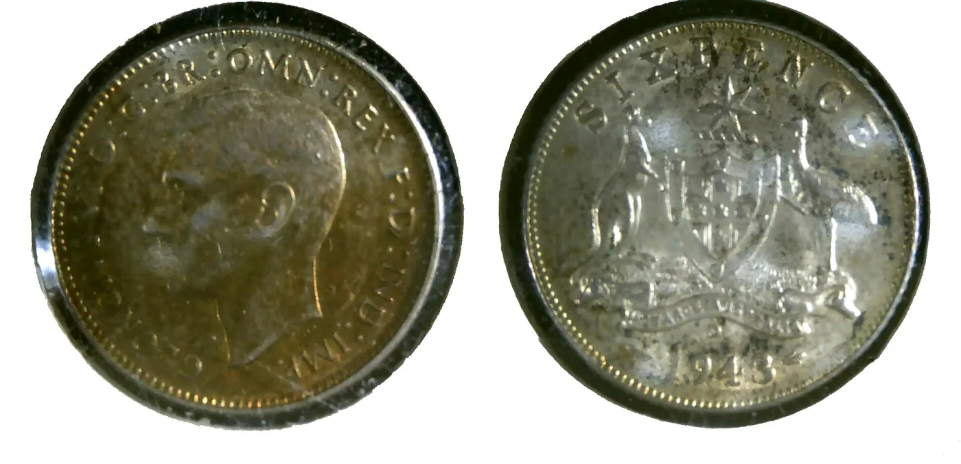 Obverse and reverse of an Australian sixpence dated 1943, a bare-headed king on one side and the Commonwealth coat of arms on the other