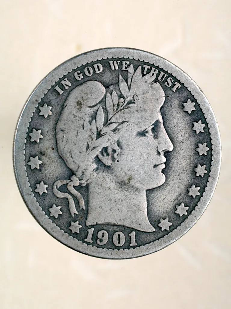Well-worn obverse of a 1901 Philadelphia Barber quarter with the headband smooth and no LIBERTY letters remaining