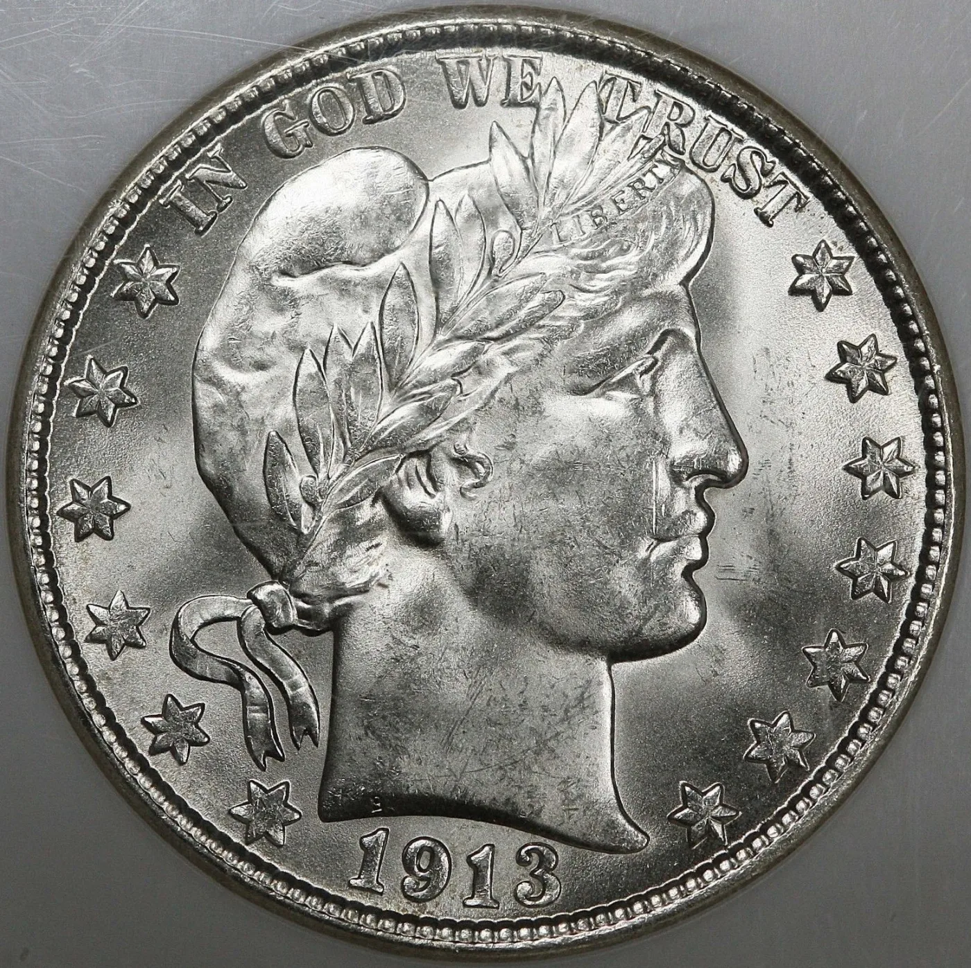 Uncirculated obverse of a 1913-D Barber half dollar showing the same Liberty head portrait at half-dollar size, dated 1913