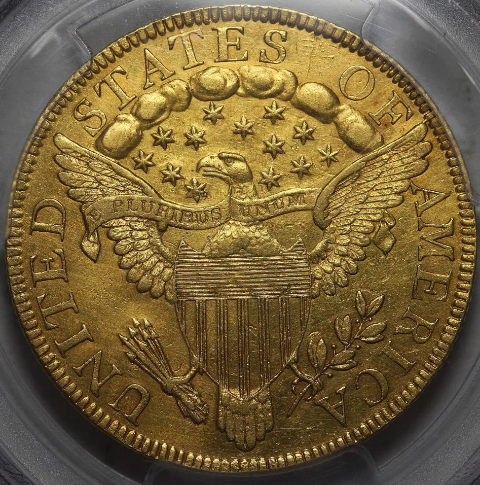 Heraldic Eagle reverse in a certified holder: eagle with a striped shield on its breast, E PLURIBUS UNUM on a banner, clouds and stars above, arrows in the talon at the viewer's left and an olive branch at the right