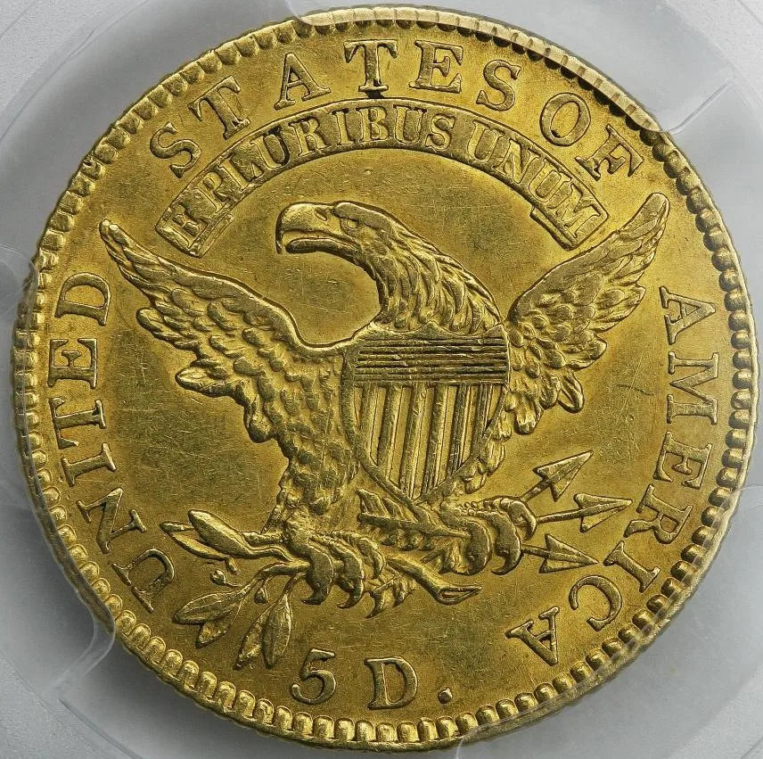 Reverse of an 1818 half eagle in a PCGS holder showing the heraldic eagle, the E PLURIBUS UNUM scroll, and 5 D. below