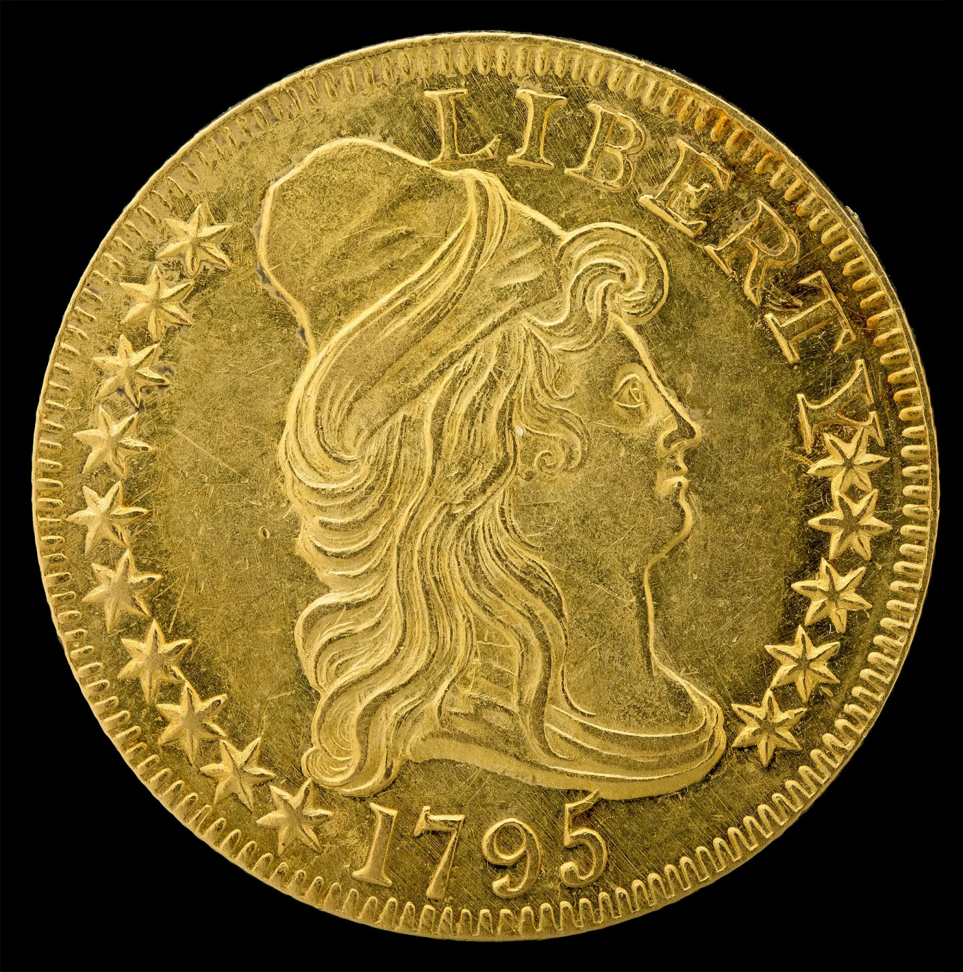 Obverse of a 1795 half eagle, Liberty facing right in a tall conical cloth cap with LIBERTY above and the date 1795 below