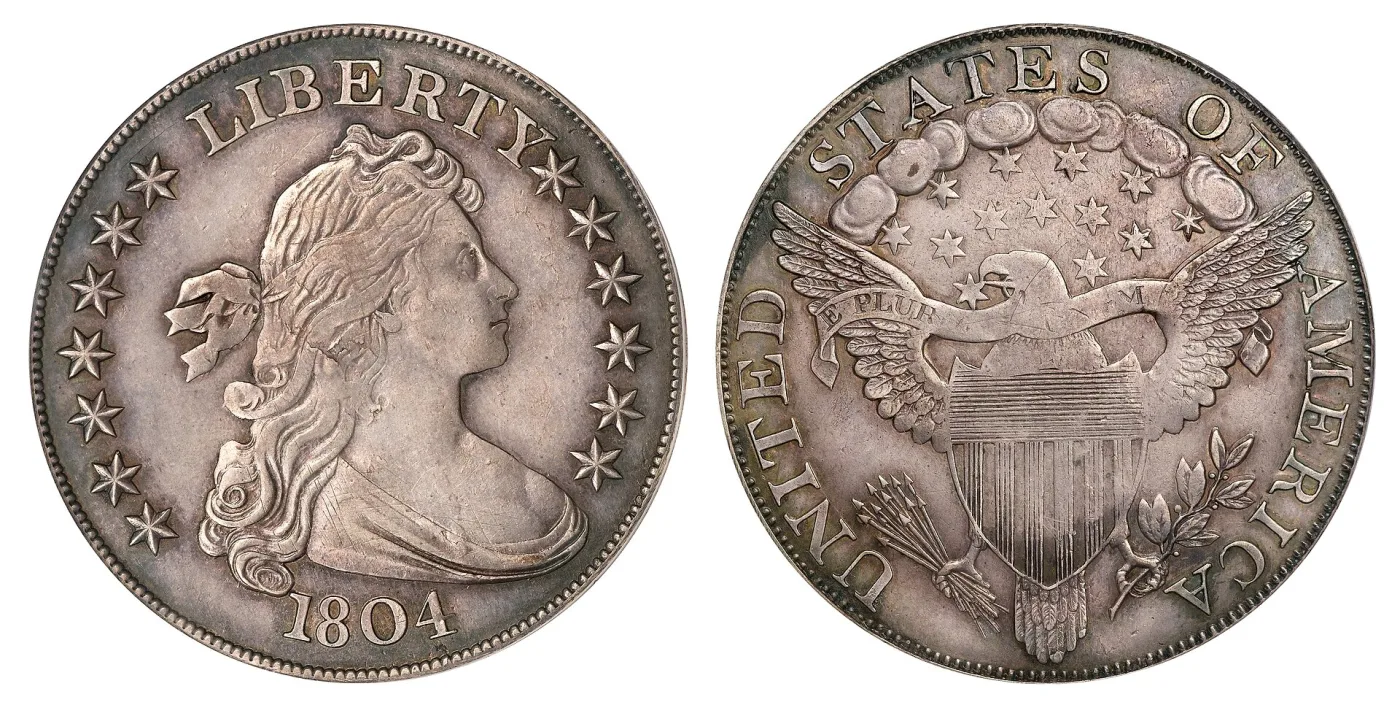Obverse and reverse of a Class III 1804-dated Draped Bust dollar in neutral silver-grey, the obverse with thirteen stars and the reverse a heraldic eagle