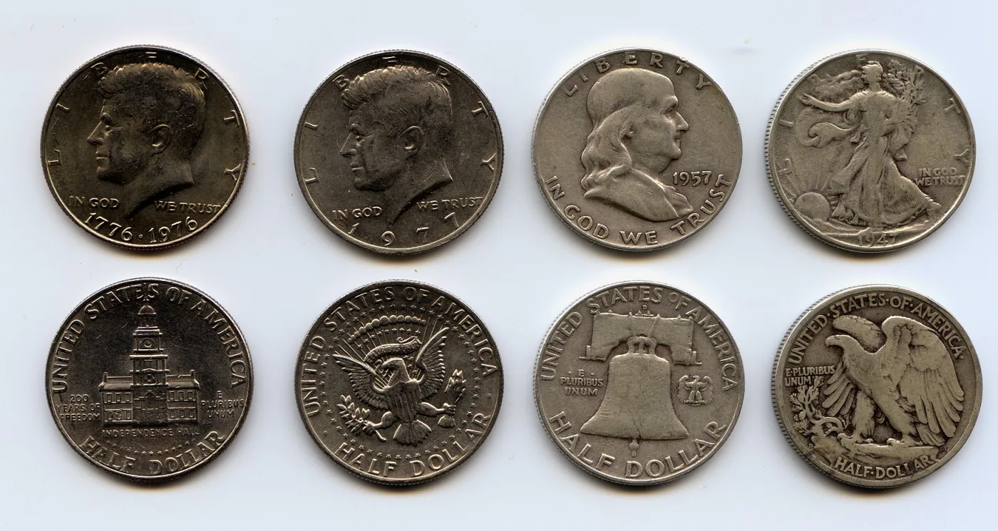 Four United States half dollar types laid out in two rows, obverses above and reverses below: a Bicentennial Kennedy, a 1977 Kennedy, a 1957 Franklin and a 1947 Walking Liberty