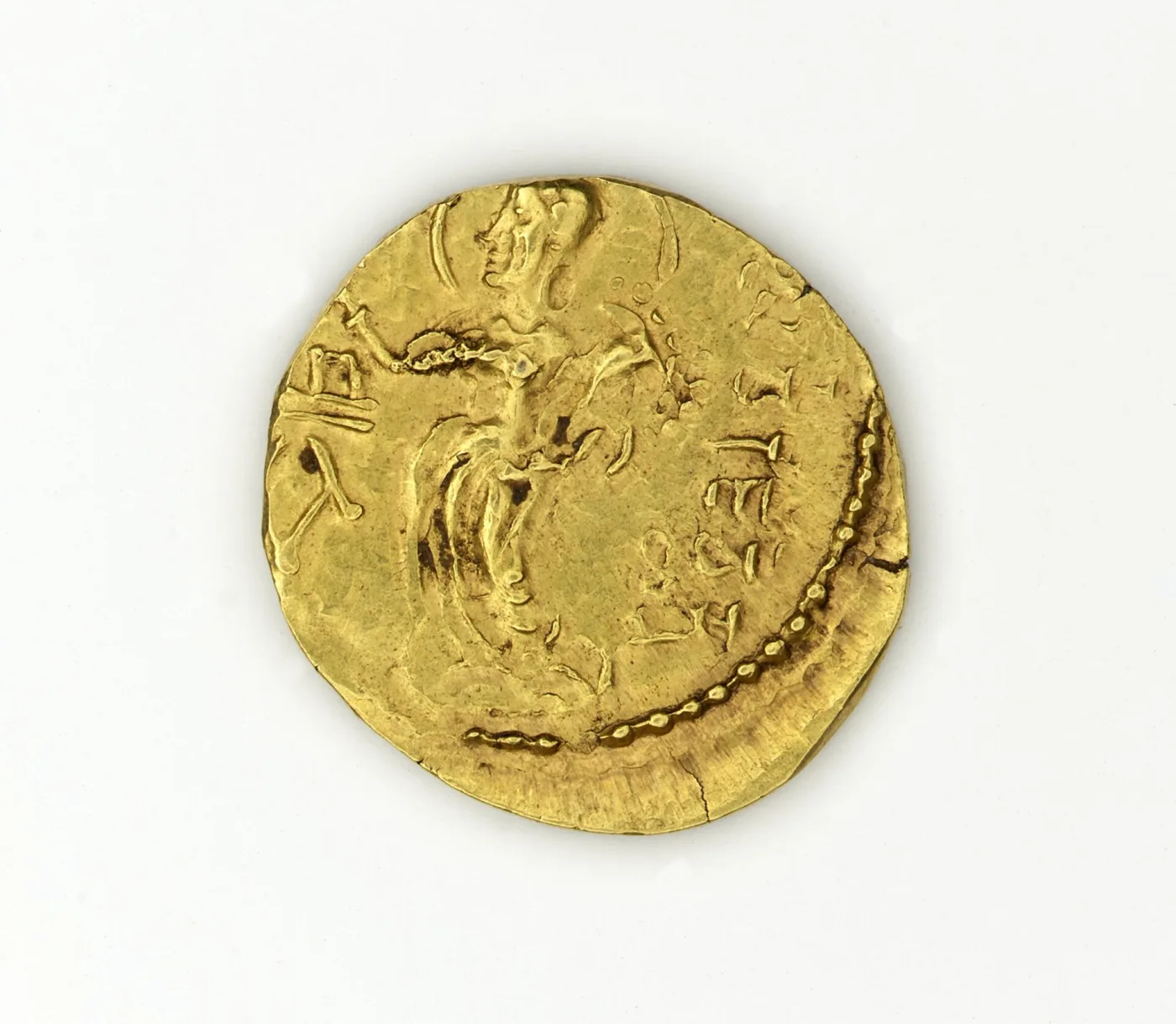 Gupta gold dinara of Kacha, the king standing with a standard and a Brahmi legend running around the edge