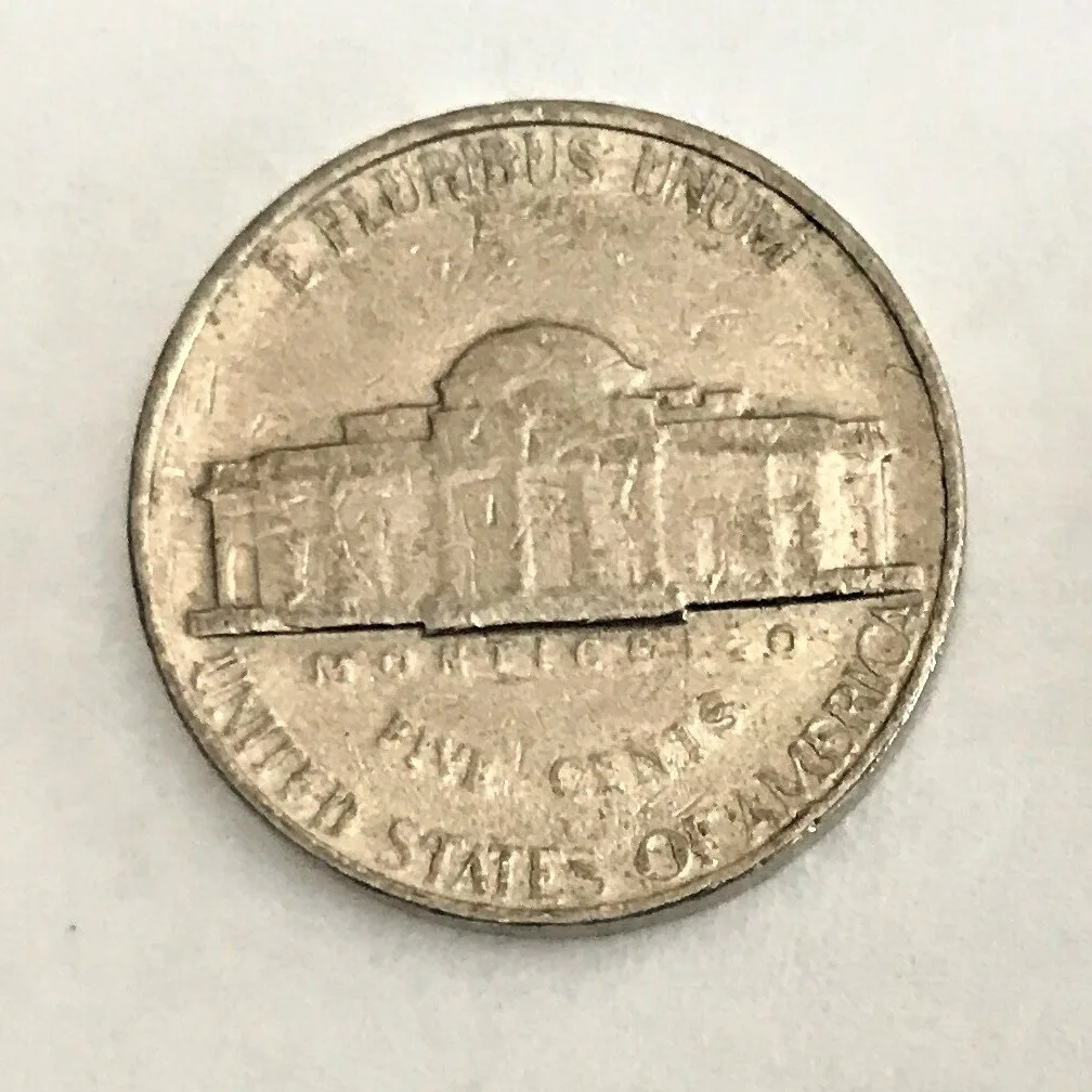 Reverse of a circulated Jefferson nickel on which the staircase below the portico has worn down to a single flat bar with no separation between steps