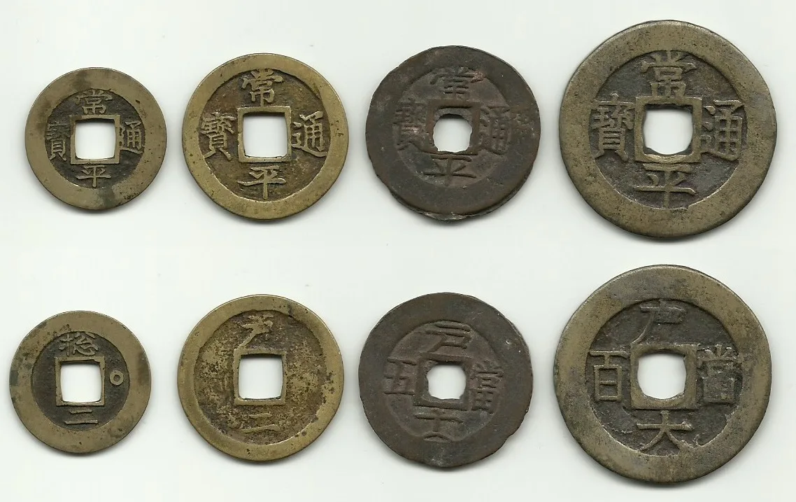 Eight Korean Sangpyeong Tongbo cash coins arranged in two rows by size, each round with a square central hole and four Chinese characters
