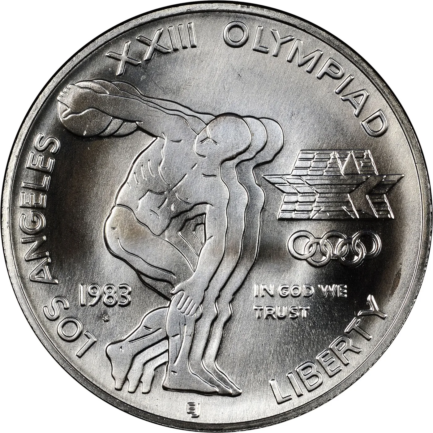 Obverse of a 1983 Los Angeles Olympics commemorative silver dollar showing three athletes' torsos