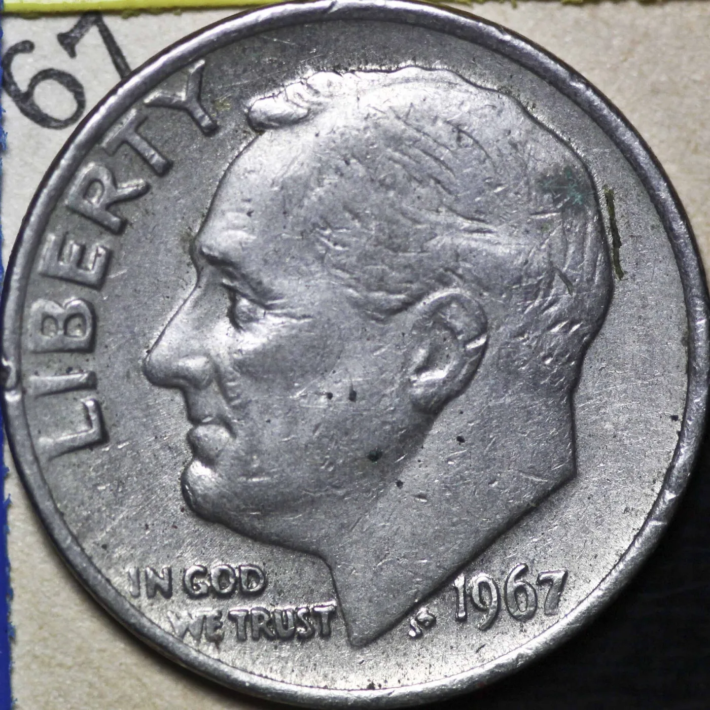 Obverse of a 1967 Roosevelt dime with no mint mark above the date