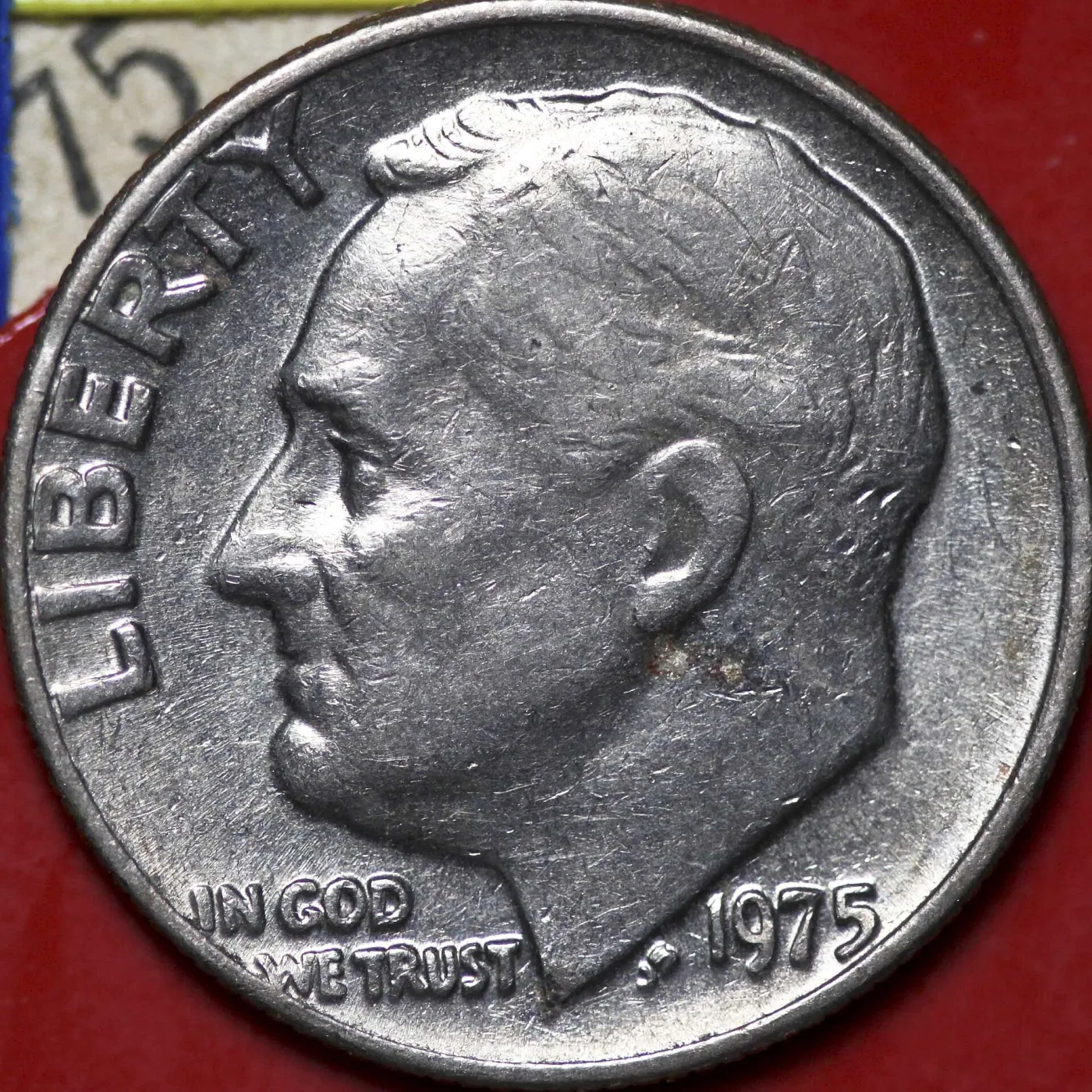 Obverse of a 1975 Roosevelt dime struck at Philadelphia, with no mint mark above the date