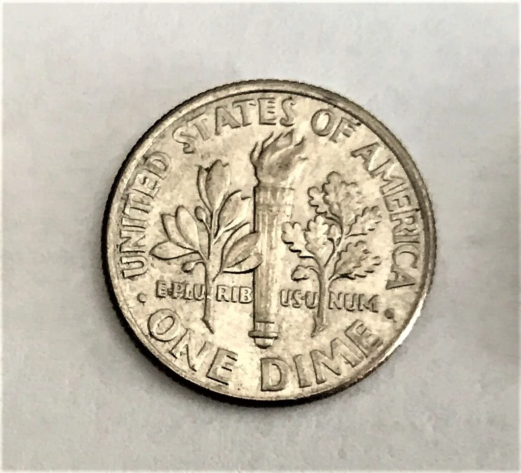 Reverse of a worn clad Roosevelt dime with an empty field beside the torch base and torch bands merged into the handle