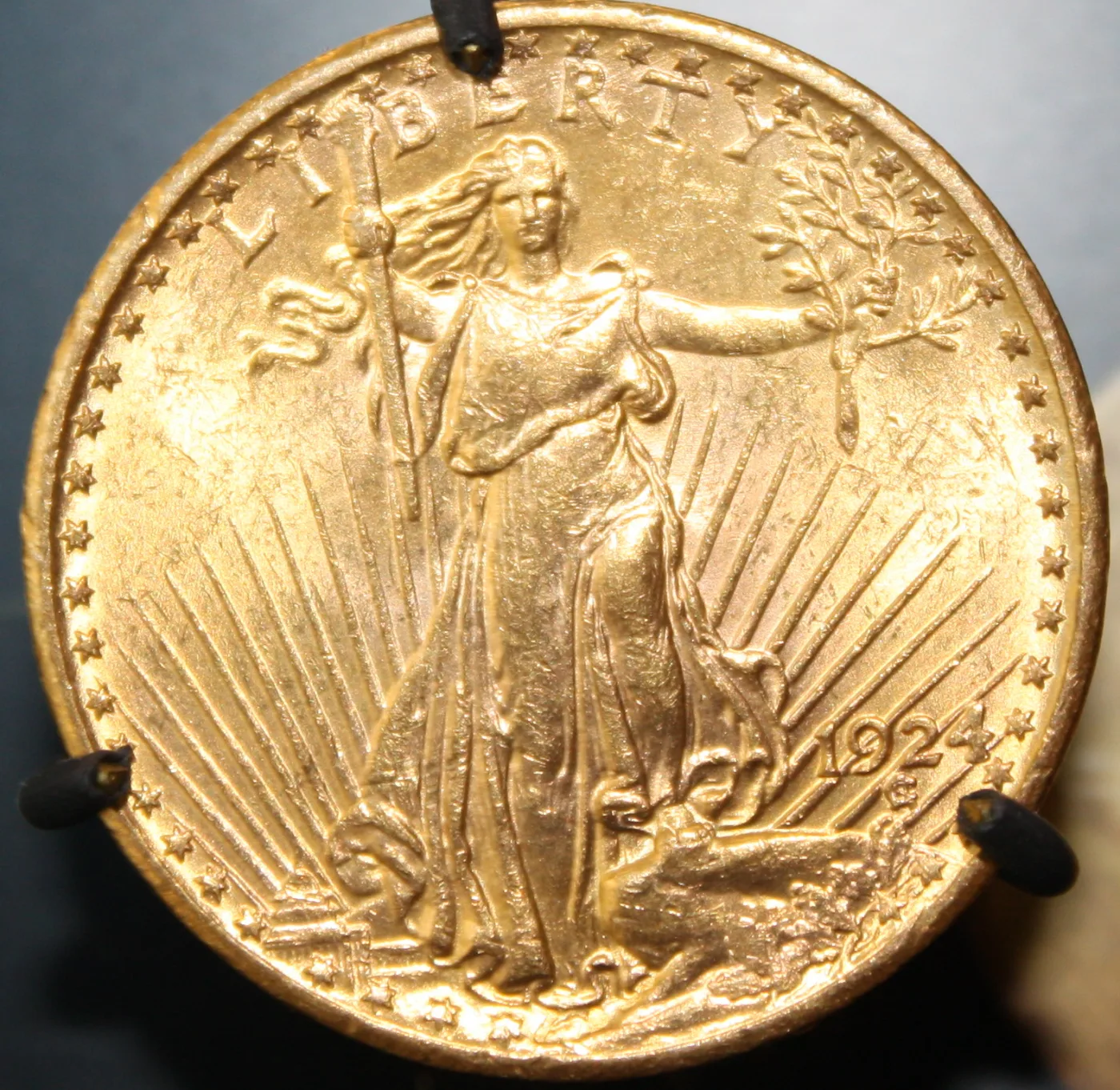 Obverse of a 1924 Saint-Gaudens double eagle in low relief, the date 1924 at the lower right with the field above the numerals bare of any mint mark
