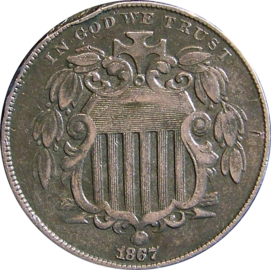 Obverse of a circulated 1867 Shield nickel, dark toned, with the horizontal lines in the chief of the shield partly worn and the olive leaves flattened